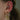 Öra med två flatpiercingar, ringpiercing och flera lobepiercingar med hoops, ormberlock och kristallberlock.