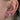 Öronstyling med forward helix piercing, helixring och flera piercingsmycken i blankt stål